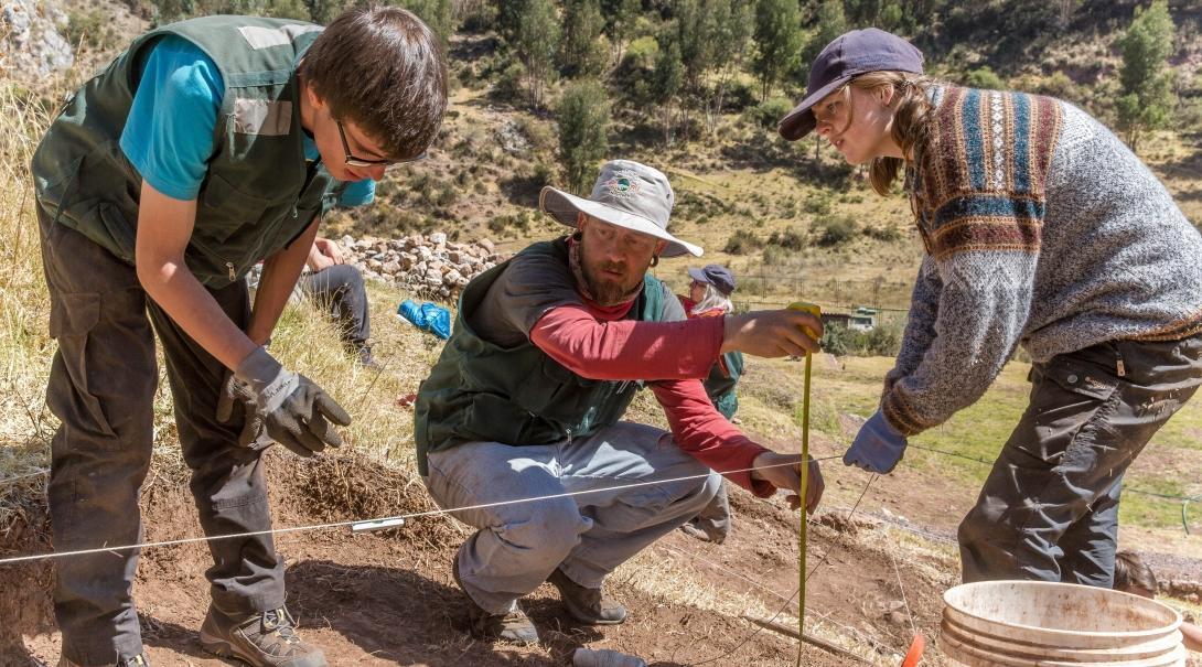 Two Projects Abroad volunteers checking the dimensions of a dig site during their archaeology volunteering in Peru. Two volunteers are pictured checking the dimensions of a dig site as part of their archaeology volunteering in Peru with Projects Abroad.